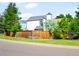 Home's exterior showcases a well-maintained yard, privacy fence, and neighborhood setting at 9654 W Elmhurst Pl, Littleton, CO 80128