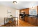 Kitchen with stainless steel appliances, stylish countertops, wood floors and breakfast nook at 9654 W Elmhurst Pl, Littleton, CO 80128