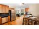 Open kitchen flows into a living room area with a lovely fireplace and stainless appliances at 9654 W Elmhurst Pl, Littleton, CO 80128