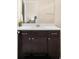 Bathroom vanity features espresso cabinetry, neutral walls, and a white countertop, with a large mirror at 15546 W 64Th Loop # C, Arvada, CO 80007