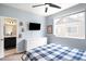 Comfortable bedroom with a ceiling fan, white dresser, and attached bathroom with a sleek black vanity at 15546 W 64Th Loop # C, Arvada, CO 80007