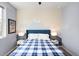 Colorful bedroom with mountain themed accent wall, soft lighting, and large bed offers a cozy retreat at 15546 W 64Th Loop # C, Arvada, CO 80007