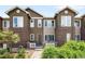 Attractive two-story townhome with brick accents, white picket fence, and manicured landscaping at 15546 W 64Th Loop # C, Arvada, CO 80007