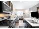 Contemporary kitchen with dark cabinetry, stainless appliances, and open-concept design at 15546 W 64Th Loop # C, Arvada, CO 80007
