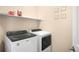 Laundry room features a newer Whirlpool washer and dryer, with storage shelf at 15546 W 64Th Loop # C, Arvada, CO 80007