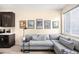 Cozy living room with a gray sofa, modern art, and plenty of natural light at 15546 W 64Th Loop # C, Arvada, CO 80007