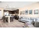 Open-concept living room and kitchen with modern decor and hardwood flooring at 15546 W 64Th Loop # C, Arvada, CO 80007
