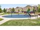 Community playground with blue mulch, swings, slide and adjacent lawn and landscaping at 15546 W 64Th Loop # C, Arvada, CO 80007