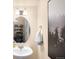 Stylish powder room boasts an oval mirror, modern fixtures, and an elegant black and white forest print at 15546 W 64Th Loop # C, Arvada, CO 80007