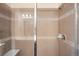 Modern shower with glass doors, tiled walls and a built-in bench offers a spa-like experience at 15546 W 64Th Loop # C, Arvada, CO 80007