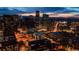 Aerial night view of the Denver skyline with high-rise buildings and city lights against a colorful twilight sky at 1827 N Grant St # 1000, Denver, CO 80203