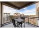 Balcony with wrought iron railing, table and chairs and a beautiful city view at 1827 N Grant St # 1000, Denver, CO 80203
