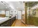 A stylish bathroom features a double sink vanity, decorative butterflies, and a glass enclosed shower with tiled walls at 1827 N Grant St # 1000, Denver, CO 80203