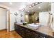A luxurious bathroom featuring double sinks, sleek fixtures, elegant lighting, and a large mirror at 1827 N Grant St # 1000, Denver, CO 80203