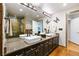 A luxurious bathroom featuring double sinks, sleek fixtures, elegant lighting, and a glass shower enclosure at 1827 N Grant St # 1000, Denver, CO 80203