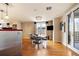 Elegant dining area with a glass table, modern chairs, chandelier, and city views from the balcony at 1827 N Grant St # 1000, Denver, CO 80203
