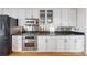 Modern kitchen with stainless steel appliances, granite countertops, and white cabinetry at 1827 N Grant St # 1000, Denver, CO 80203