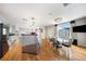 Open kitchen and dining area with stainless steel appliances, glass table and chairs, and hardwood floors at 1827 N Grant St # 1000, Denver, CO 80203