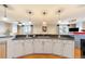 Modern kitchen with pendant lighting, granite countertops, and white cabinets at 1827 N Grant St # 1000, Denver, CO 80203