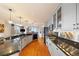 Modern kitchen with stainless steel appliances, granite countertops, a breakfast bar, and pendant lighting at 1827 N Grant St # 1000, Denver, CO 80203