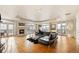 Bright living room with hardwood floors, fireplace, a large black couch and french doors to a balcony at 1827 N Grant St # 1000, Denver, CO 80203
