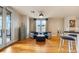Stylish living room with comfortable seating, modern decor, hardwood floors, and a balcony overlooking the city at 1827 N Grant St # 1000, Denver, CO 80203