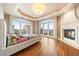 Bright and airy main bedroom with a fireplace, hardwood floors, and large windows offering city views at 1827 N Grant St # 1000, Denver, CO 80203