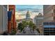 Denver's cityscape features a tree-lined street with views of the State Capitol building under a cloudy sky at 1827 N Grant St # 1000, Denver, CO 80203