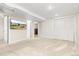 Finished basement with carpet, a large wall-mounted television and plenty of storage at 3649 N Garfield St, Denver, CO 80205