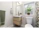 Bathroom with modern floating vanity, a window, and a toilet with coordinating botanical accents at 3649 N Garfield St, Denver, CO 80205