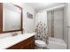 Bright bathroom featuring a shower-tub combo, decorative shower curtain, and vanity with a wood cabinet at 3649 N Garfield St, Denver, CO 80205
