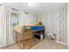 bedroom featuring a bunk bed, modern wallpaper and natural light at 3649 N Garfield St, Denver, CO 80205