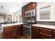 Modern kitchen featuring stainless steel appliances, granite countertops, and dark wood cabinets at 3649 N Garfield St, Denver, CO 80205