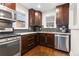 Updated kitchen with stainless steel appliances, granite countertops, and dark wood cabinets at 3649 N Garfield St, Denver, CO 80205