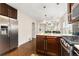 Bright, modern kitchen with stainless steel appliances and granite counters open to living spaces at 3649 N Garfield St, Denver, CO 80205