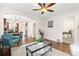 Open living room with hardwood floors and view to dining area, kitchen, and an adjacent room at 3649 N Garfield St, Denver, CO 80205
