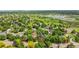 Aerial view showcases homes surrounded by mature trees, park and a lake in a quiet and lovely neighborhood at 12414 Clayton Way, Thornton, CO 80241