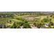 Neighborhood aerial showing a house and a large green space, including trees, grass, and nearby walking paths at 12414 Clayton Way, Thornton, CO 80241