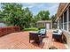Relax on the outdoor deck with wicker chairs, side tables, and lush backyard views at 12414 Clayton Way, Thornton, CO 80241