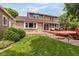 Spacious backyard featuring a multi-level deck, lush lawn, and mature landscaping at 12414 Clayton Way, Thornton, CO 80241