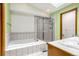 Bathroom features tiled shower, soaking tub, skylight, single sink, and green walls at 12414 Clayton Way, Thornton, CO 80241