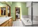 Bathroom features double sinks, soaking tub, shower, and access to a walk-in closet at 12414 Clayton Way, Thornton, CO 80241