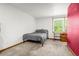 Simple bedroom with neutral carpet, work desk, and large window at 12414 Clayton Way, Thornton, CO 80241