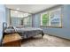 Comfortable bedroom featuring a large window, mirrored closet, and soft carpet at 12414 Clayton Way, Thornton, CO 80241