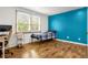 Bright bedroom with hardwood floors and large windows for ample natural light at 12414 Clayton Way, Thornton, CO 80241