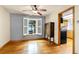 Cozy dining area with hardwood floors, white shutters, and adjacent to a gray painted wall at 12414 Clayton Way, Thornton, CO 80241