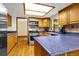 A charming kitchen features wooden cabinets, blue countertops, and stainless steel appliances at 12414 Clayton Way, Thornton, CO 80241