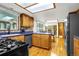 A charming kitchen features wooden cabinets, blue countertops, and modern appliances at 12414 Clayton Way, Thornton, CO 80241