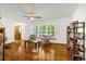 Bright living room with hardwood floors, bookshelves, a ceiling fan, and natural light at 12414 Clayton Way, Thornton, CO 80241