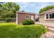 Exterior shot of backyard shed with adjacent walkway, door, window, and green lawn at 12414 Clayton Way, Thornton, CO 80241